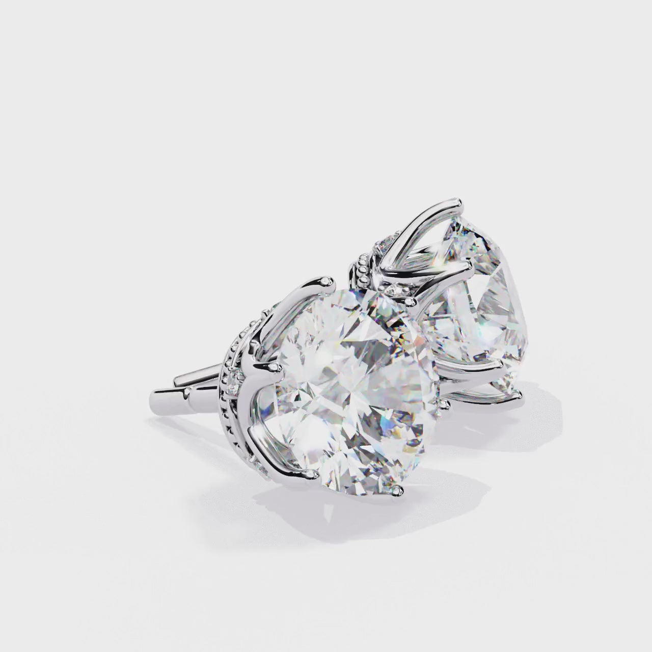 Round brilliant-cut earrings featuring six prongs.